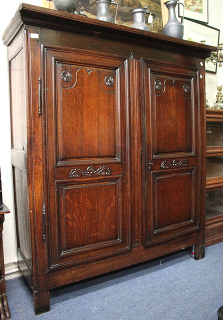 Appraisal: AN ANTIQUE WALNUT FRENCH TWO DOOR ARMOIRE with carved decoration