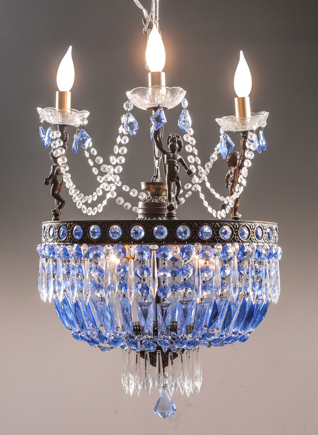 Appraisal: FIGURAL PUTTI BLUE GLASS CHANDELIER lights total on the upward