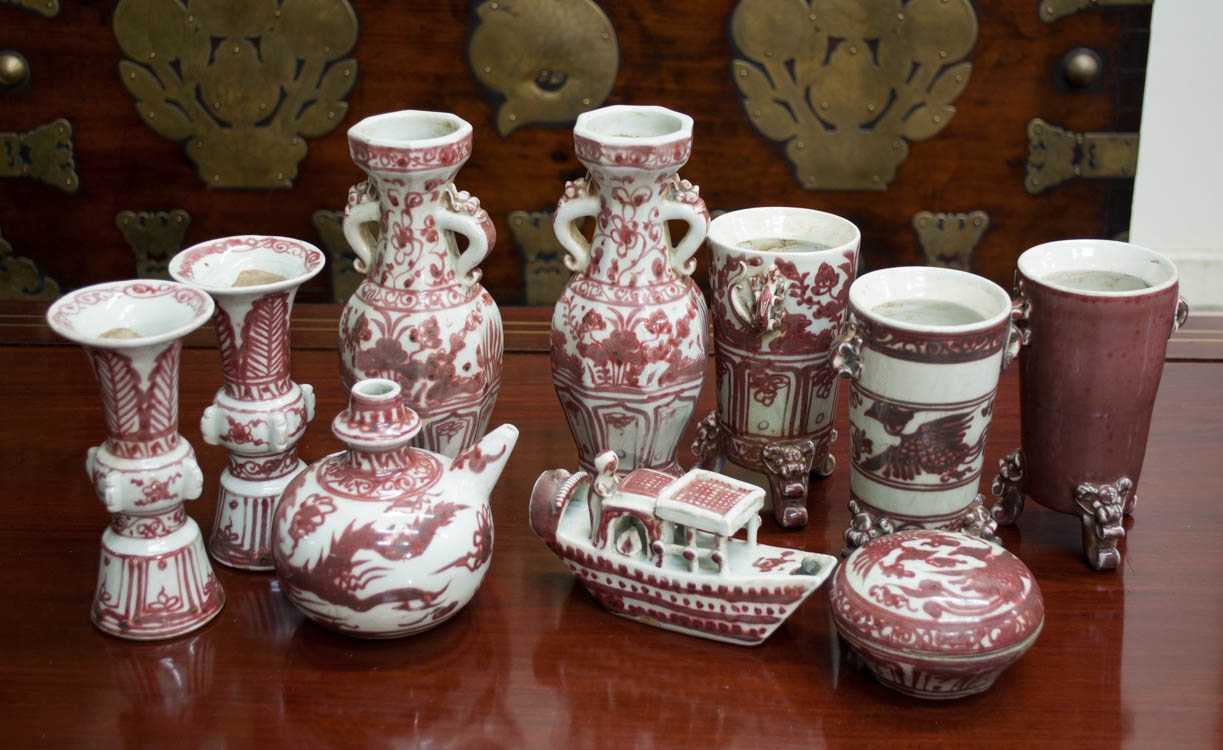 Appraisal: TEN CHINESE IRON RED PORCELAIN VESSELS including split-handled vases tri-foot