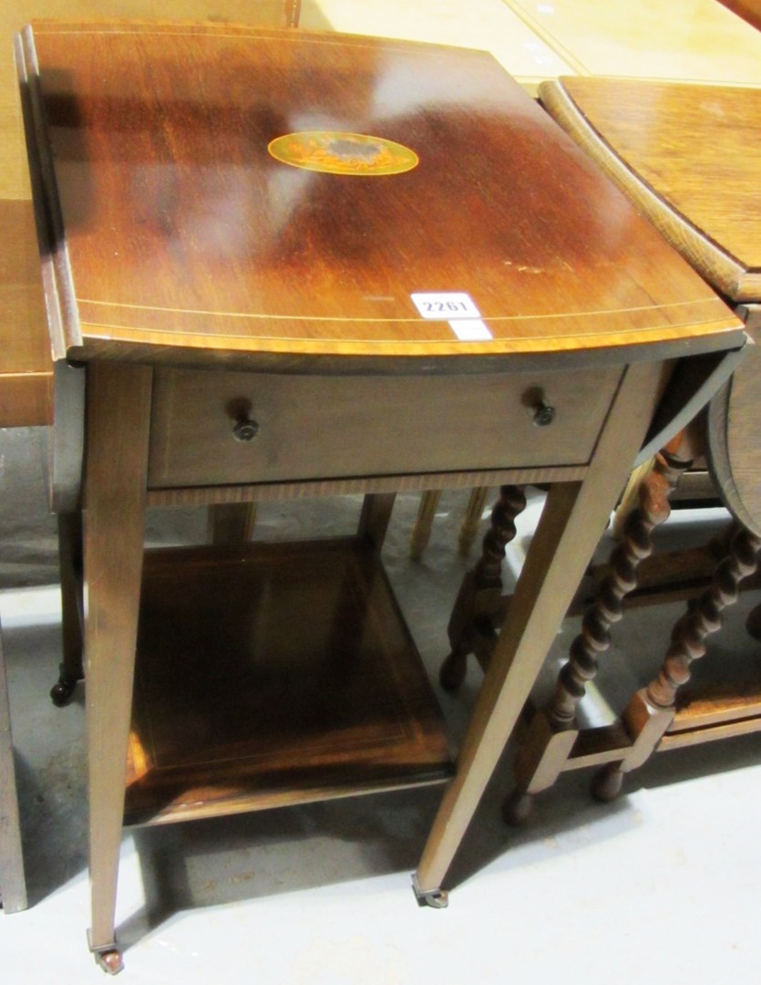 Appraisal: A mahogany and inlaid drop flap two tier table