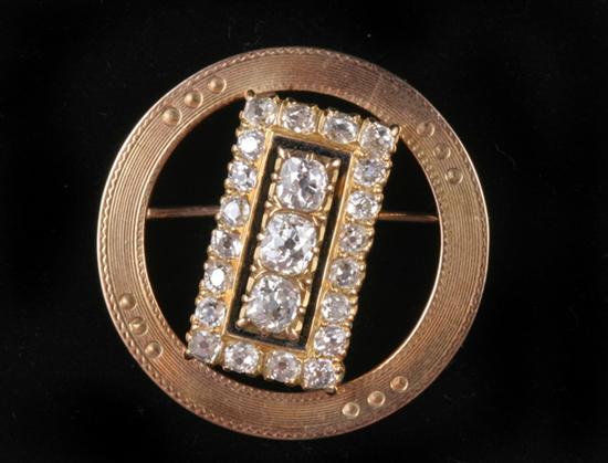 Appraisal: K YELLOW GOLD AND DIAMOND BAR-AND-CIRCLE PIN Delicately reeded circle