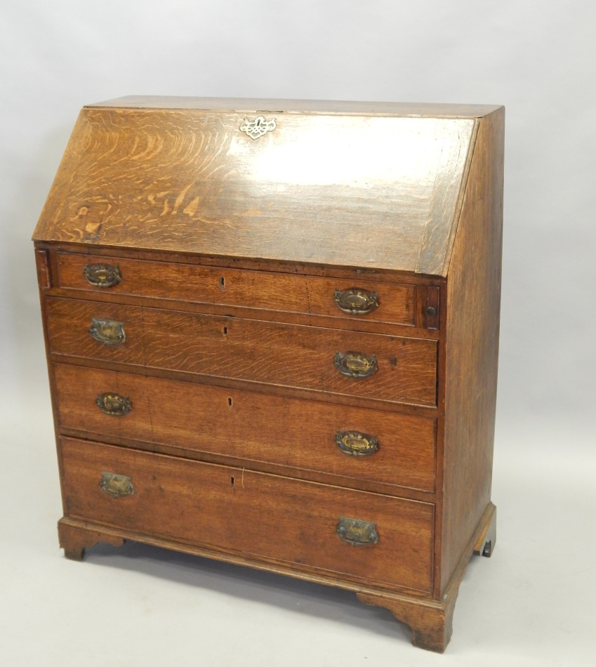 Appraisal: A George III oak bureau the fall enclosing a fitted