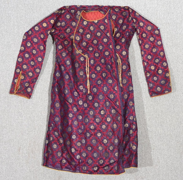 Appraisal: A TRADITIONAL MUGHAL CHILDS SILK ANGRAKHA with silver thread rosette