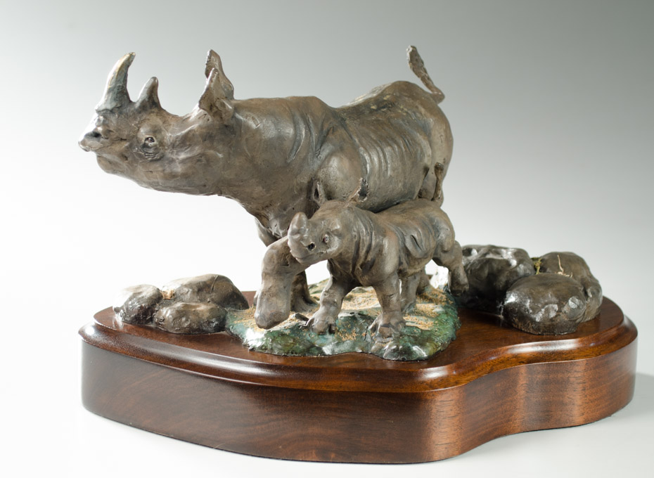 Appraisal: DAN HUBER th Century Oregon CAST BRONZE SCULPTURE of rhinos