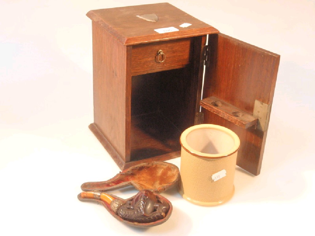 Appraisal: An Edwardian oak smokers cabinet with claw carved Meerschaum pipe