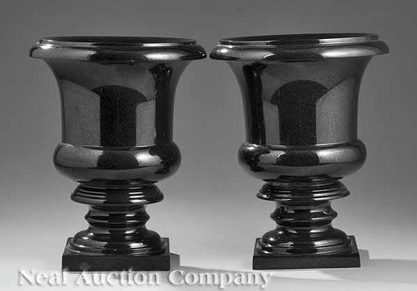 Appraisal: A Pair of Black Granite Campagna Urns everted lip ring