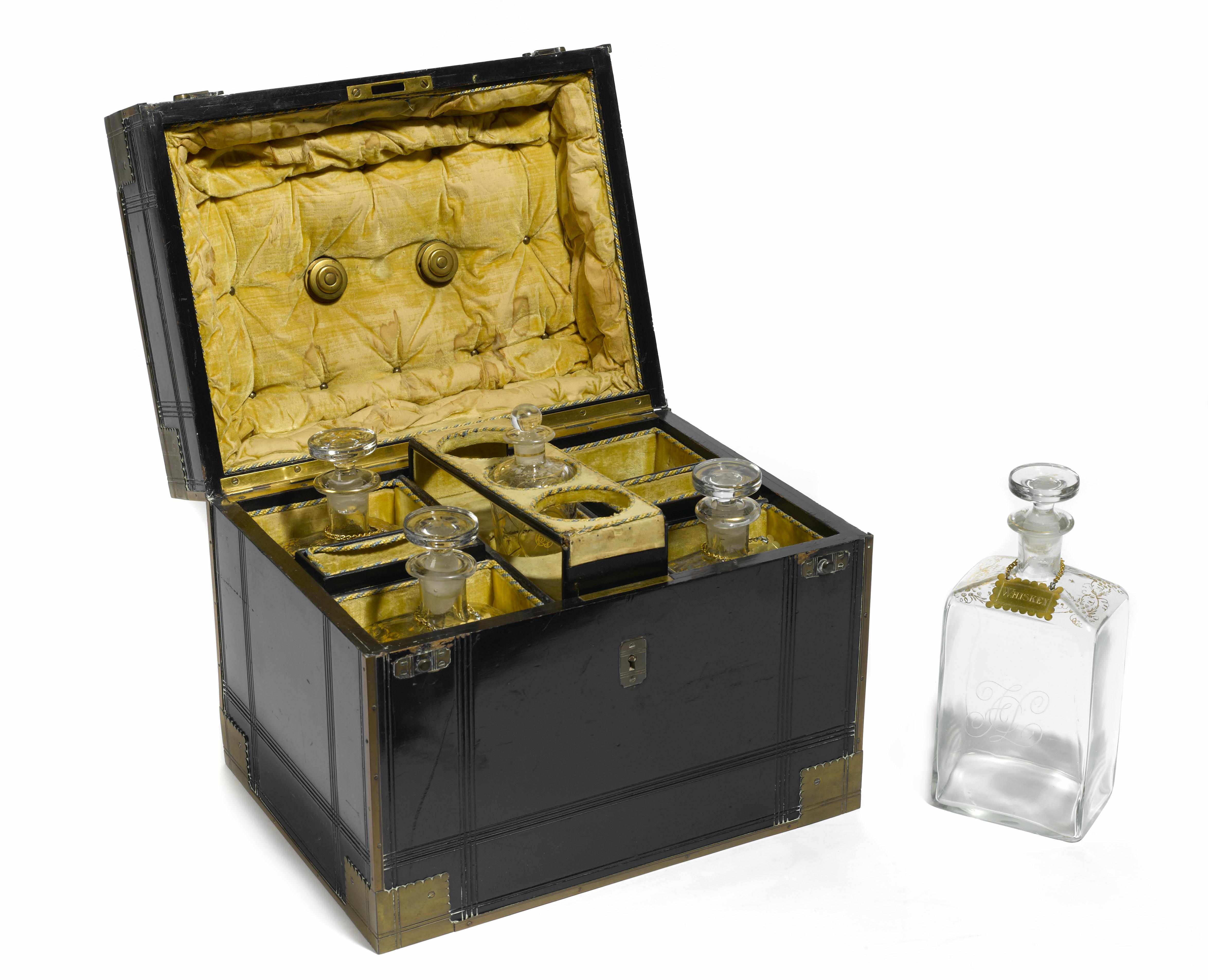 Appraisal: A Continental brass mounted ebonized liqueur set The fitted box