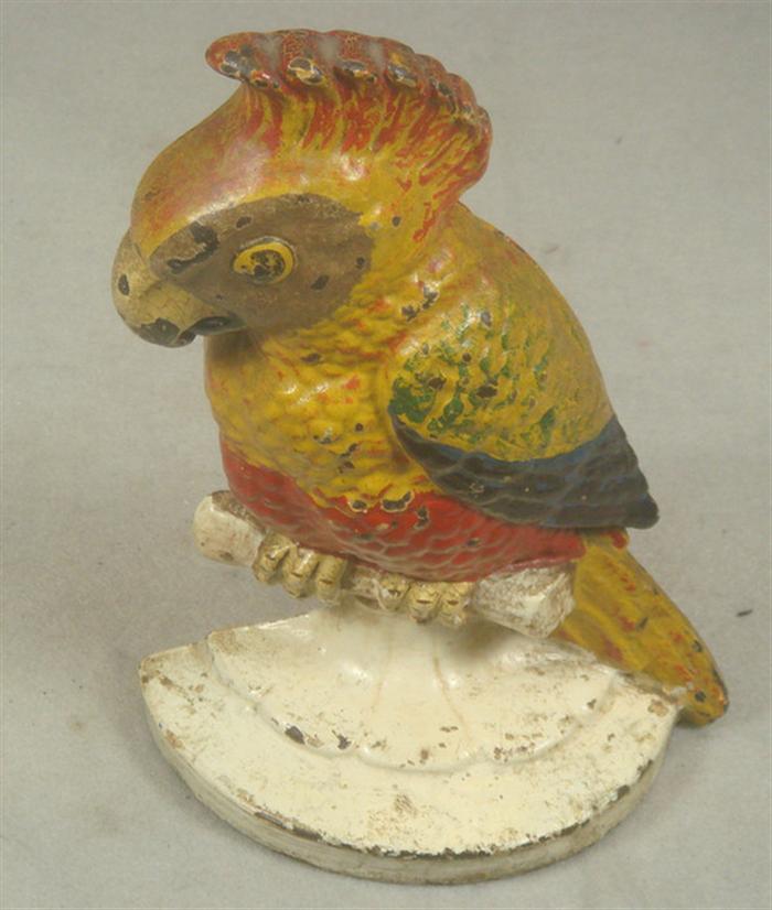 Appraisal: Cast iron doorstop parrot perching on branch stamped on back