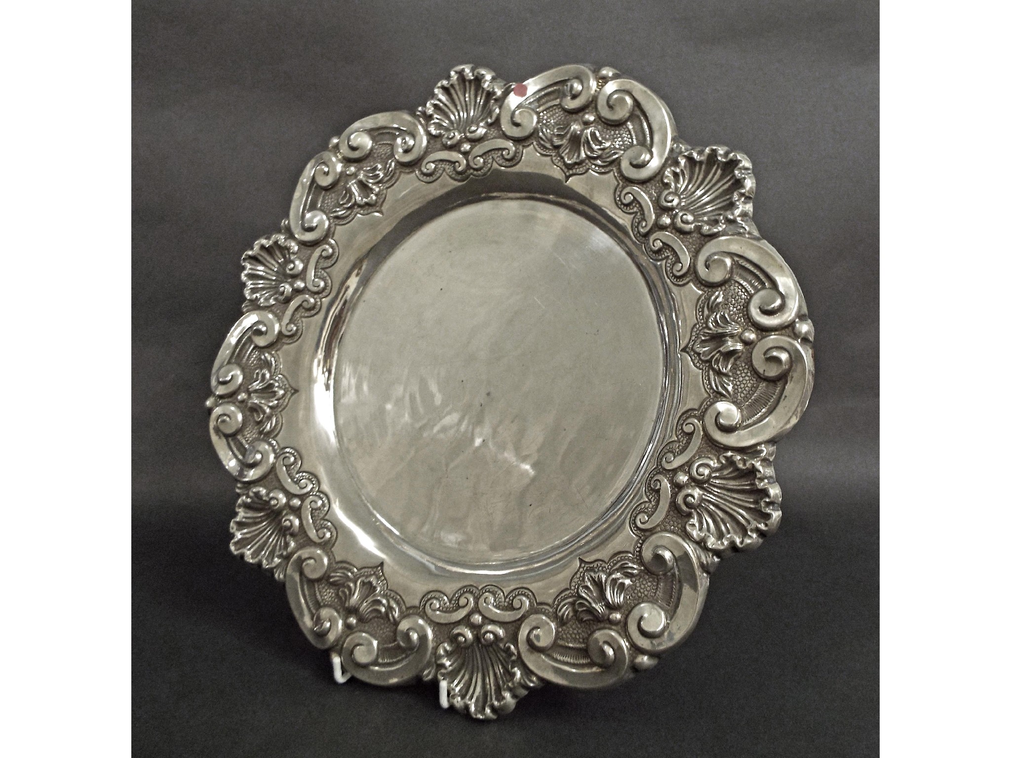 Appraisal: Portuguese white metal salver with embossed scallop shell and scrolled