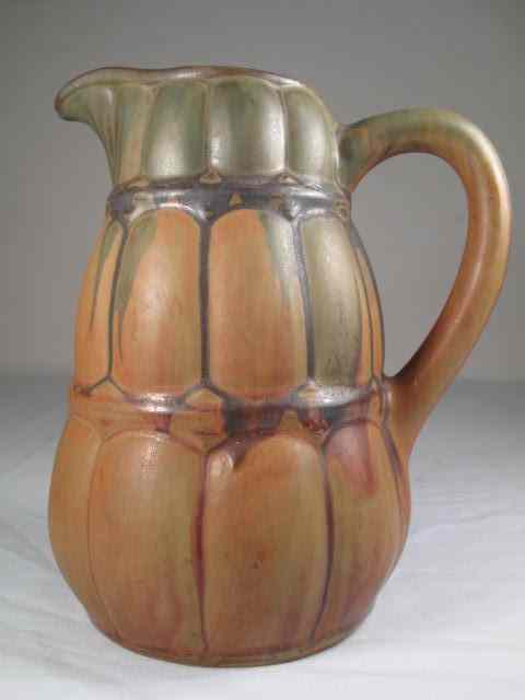 Appraisal: Denbac art pottery pitcher Weaved pattern with drip glaze style