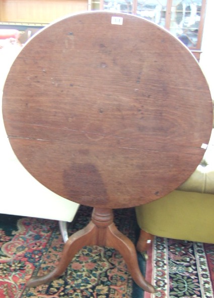 Appraisal: A George III oak snap-top occasional table the circular top