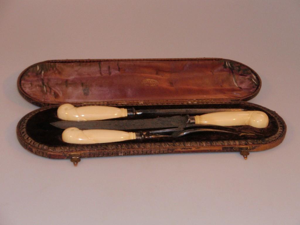 Appraisal: A thC ivory handled and steel three-piece carving set cased