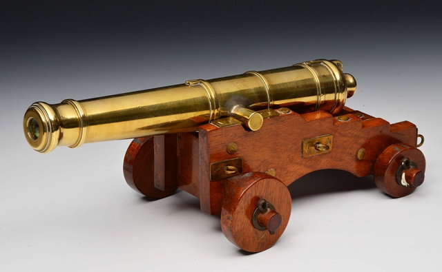 Appraisal: A BRASS TABLE TOP CANNON on a wooden carriage cm