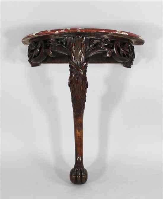 Appraisal: A Victorian carved walnut marble top console table on monopodia