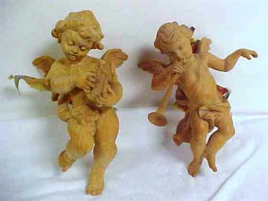 Appraisal: Italian carved wooden putti playing instruments '' h