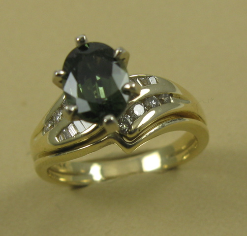 Appraisal: GREEN SAPPHIRE AND FOURTEEN KARAT GOLD RING centering an oval-cut