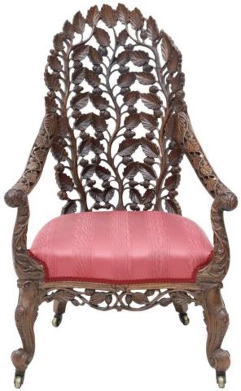 Appraisal: Burmese carved armchair late thc pierce work back climbing branches