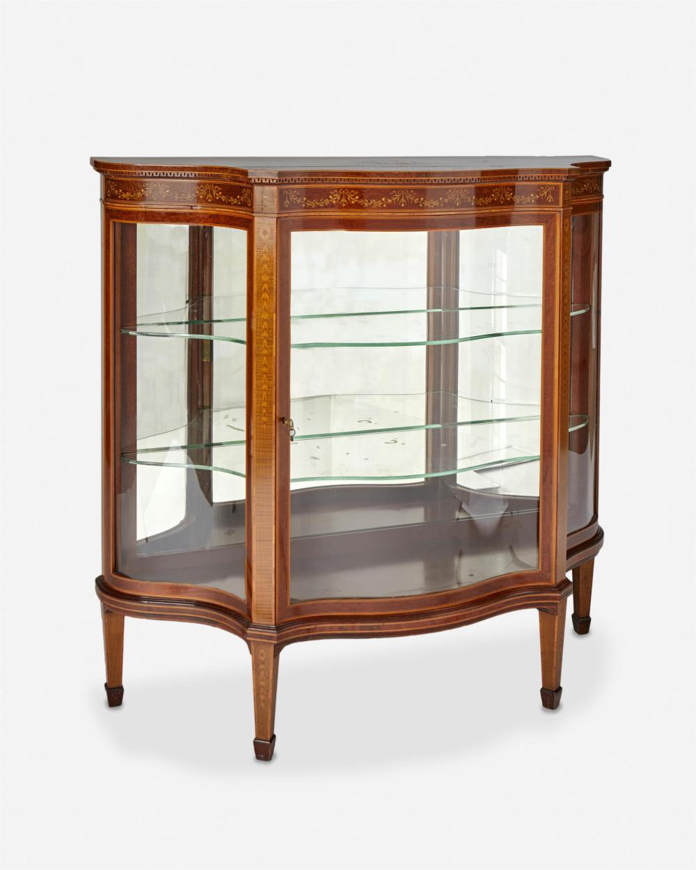 Appraisal: An English Edwardian marquetry vitrine First-quarter th Century The serpentine