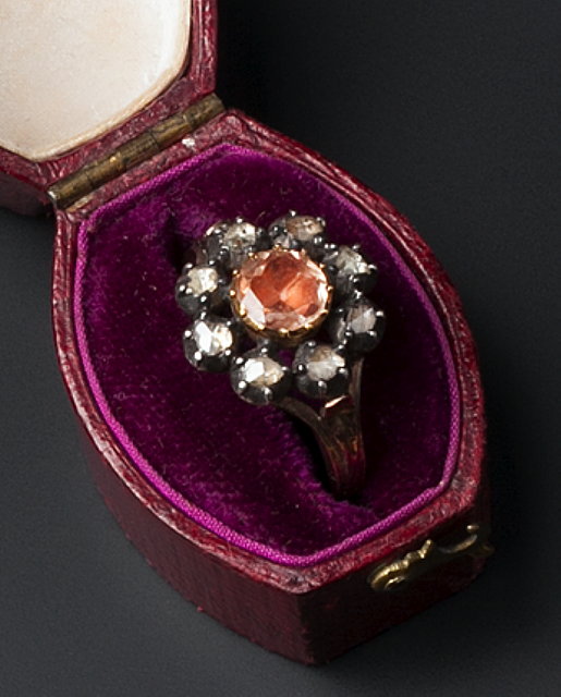 Appraisal: A TOPAZ AND DIAMOND CLUSTER RING the circular-cut topaz in