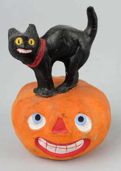 Appraisal: Black Cat Standing on Halloween Jack-O-Lantern Description A smiling jack-o-lantern