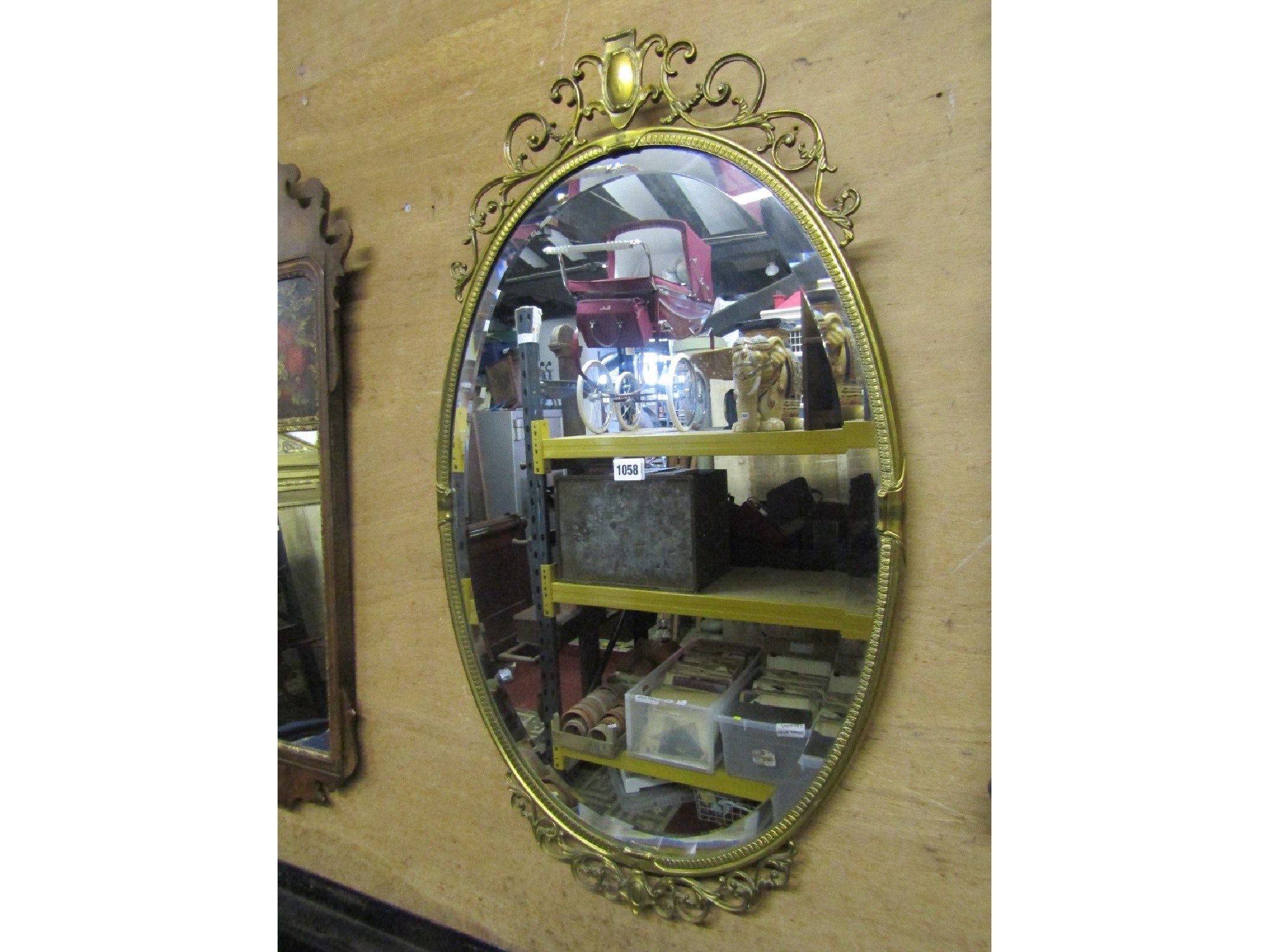 Appraisal: A cast brass framed wall mirror of oval form with