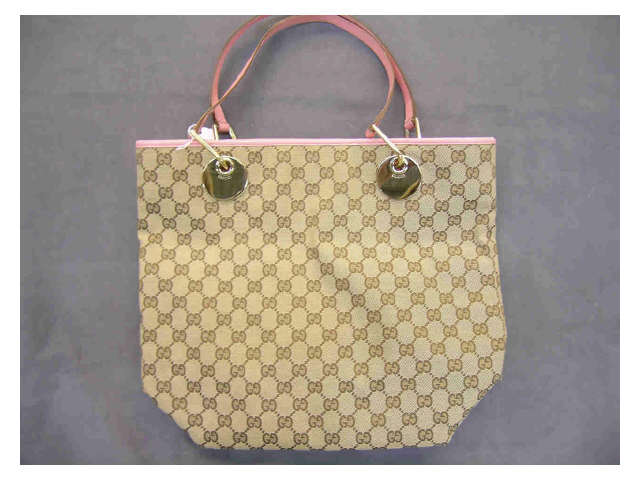 Appraisal: Gucci handbag monogrammed fabric with pink leather handles and pink