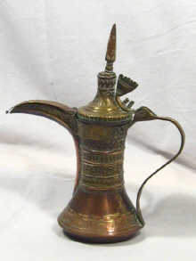 Appraisal: A brass Islamic coffee pot cm high