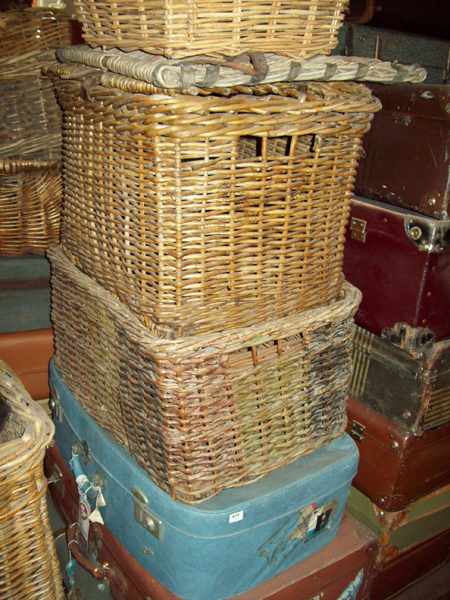 Appraisal: A COLLECTION OF FOUR 'S SUITCASES AND FIVE CANE BASKETS