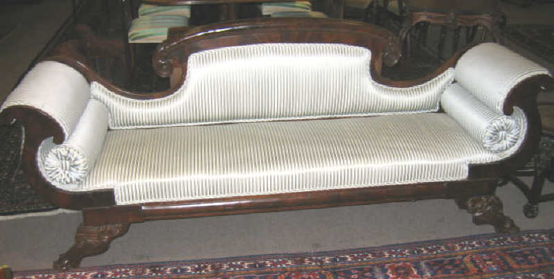 Appraisal: AMERICAN EMPIRE MAHOGANY SETTEE With slightly arched top rail terminating