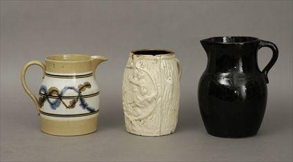 Appraisal: Three English Pitchers Including a mochaware pitcher a brown-glazed pottery