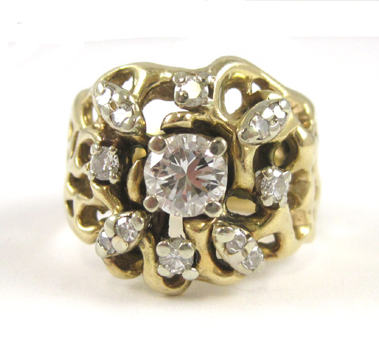 Appraisal: DIAMOND AND FOURTEEN KARAT PIERCED GOLD RING centering a round-cut