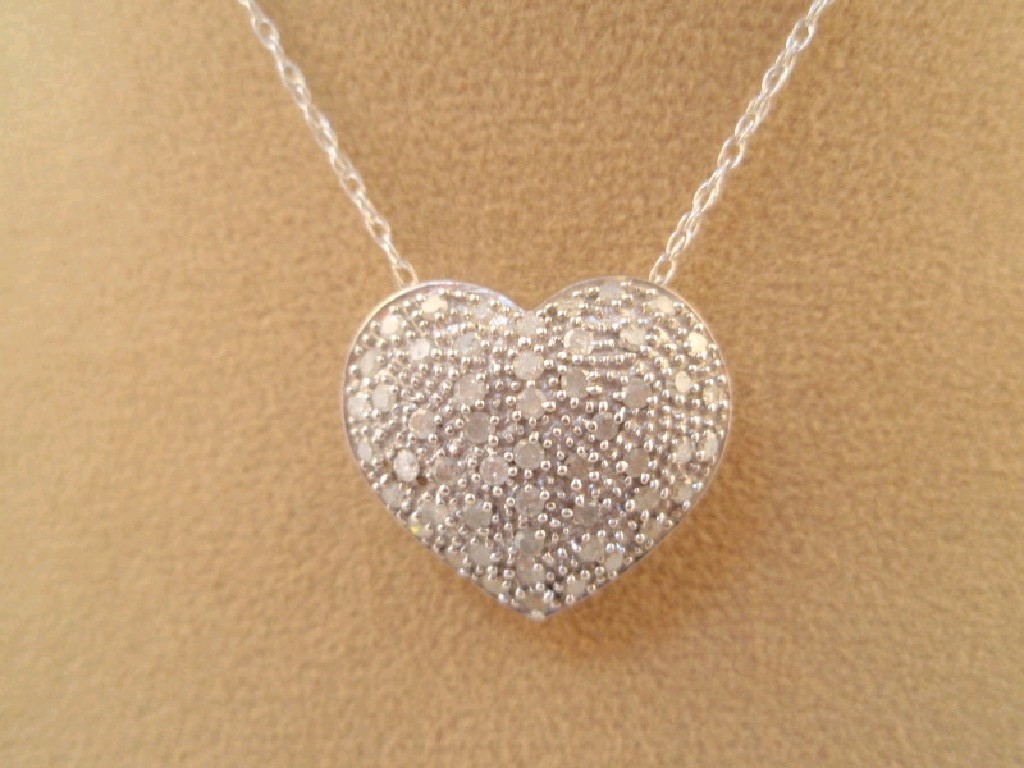 Appraisal: A ct white gold pave set heart pendant on chain