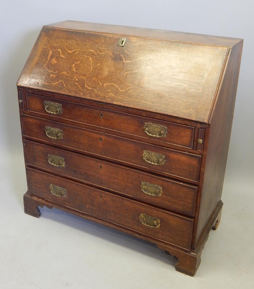 Appraisal: A George III oak and mahogany cross banded bureau the