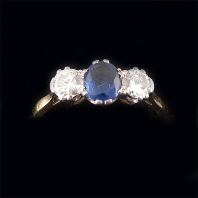 Appraisal: A three stone sapphire and diamond ring the oval sapphire