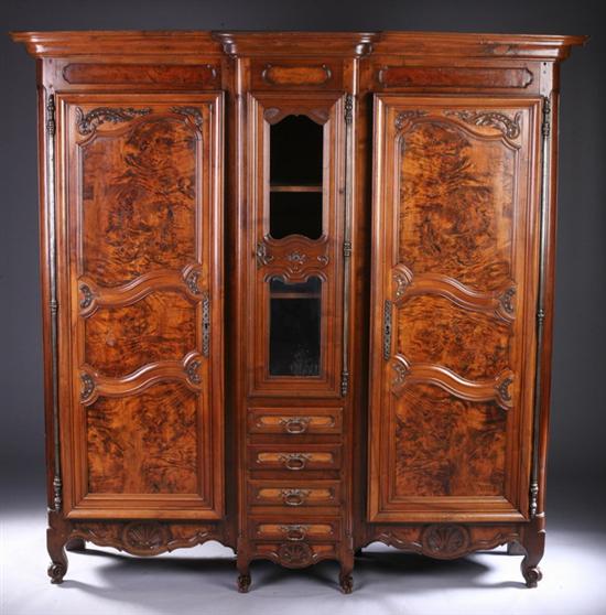 Appraisal: LOUIS XV STYLE WALNUT BREAKFRONTED CHINA CABINET th century Projecting