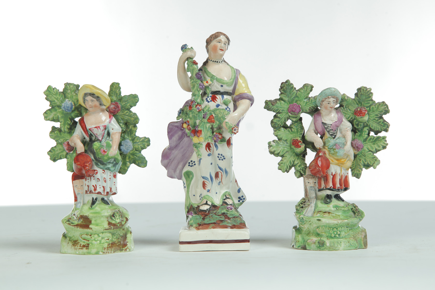 Appraisal: THREE EARLY STAFFORDSHIRE FIGURES OF LADIES England st quarter- th