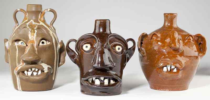 Appraisal: Three NC Pottery Folk Art Face Jugsa double handled jug