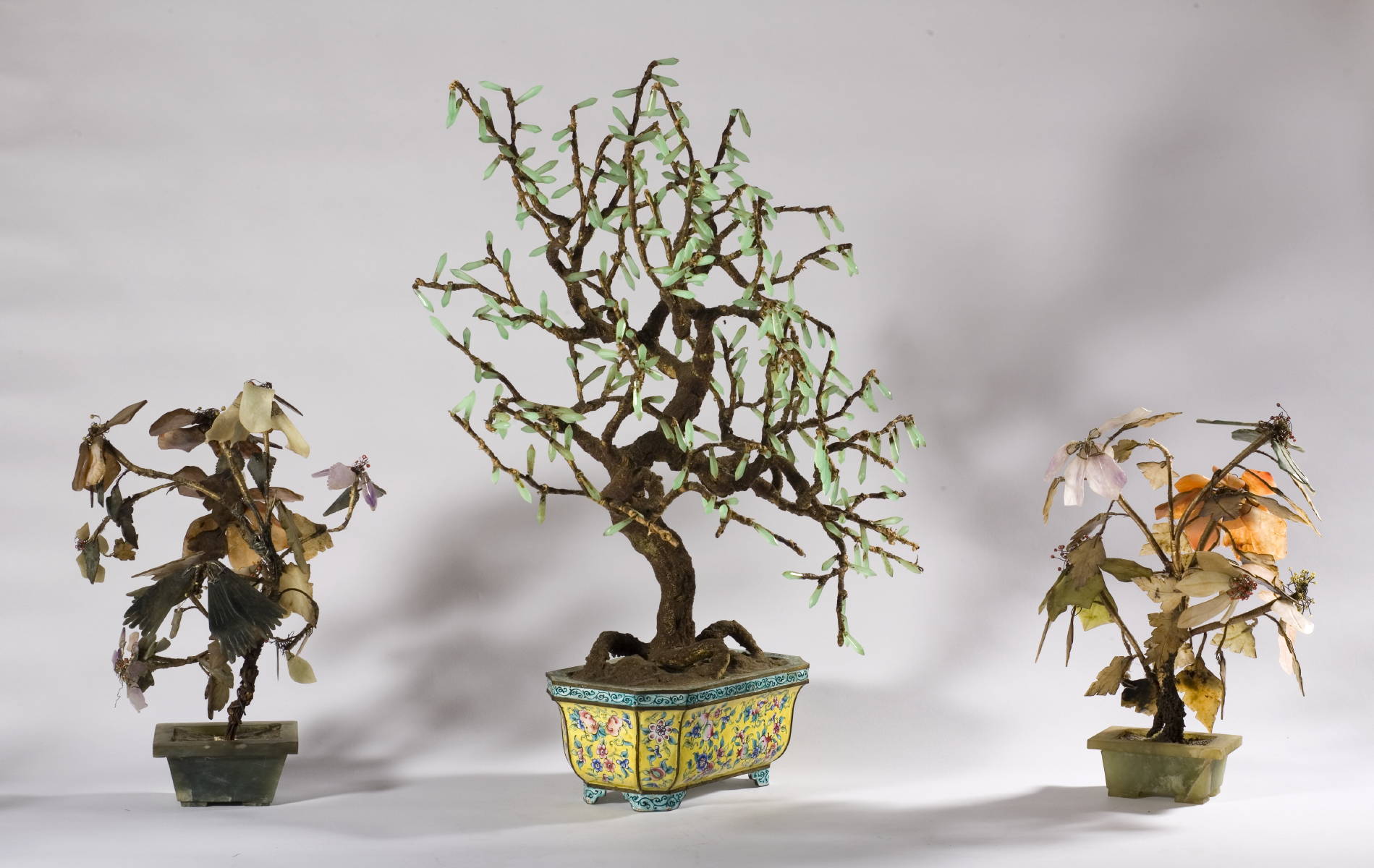 Appraisal: CHINESE HARDSTONE TREE IN PEKING ENAMEL YELLOW-GREEN PLANTER AND THREE