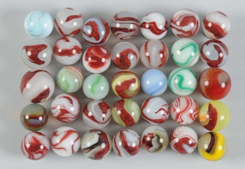 Appraisal: Assortment of Oxblood Marbles Description Includes approximately marbles Not all