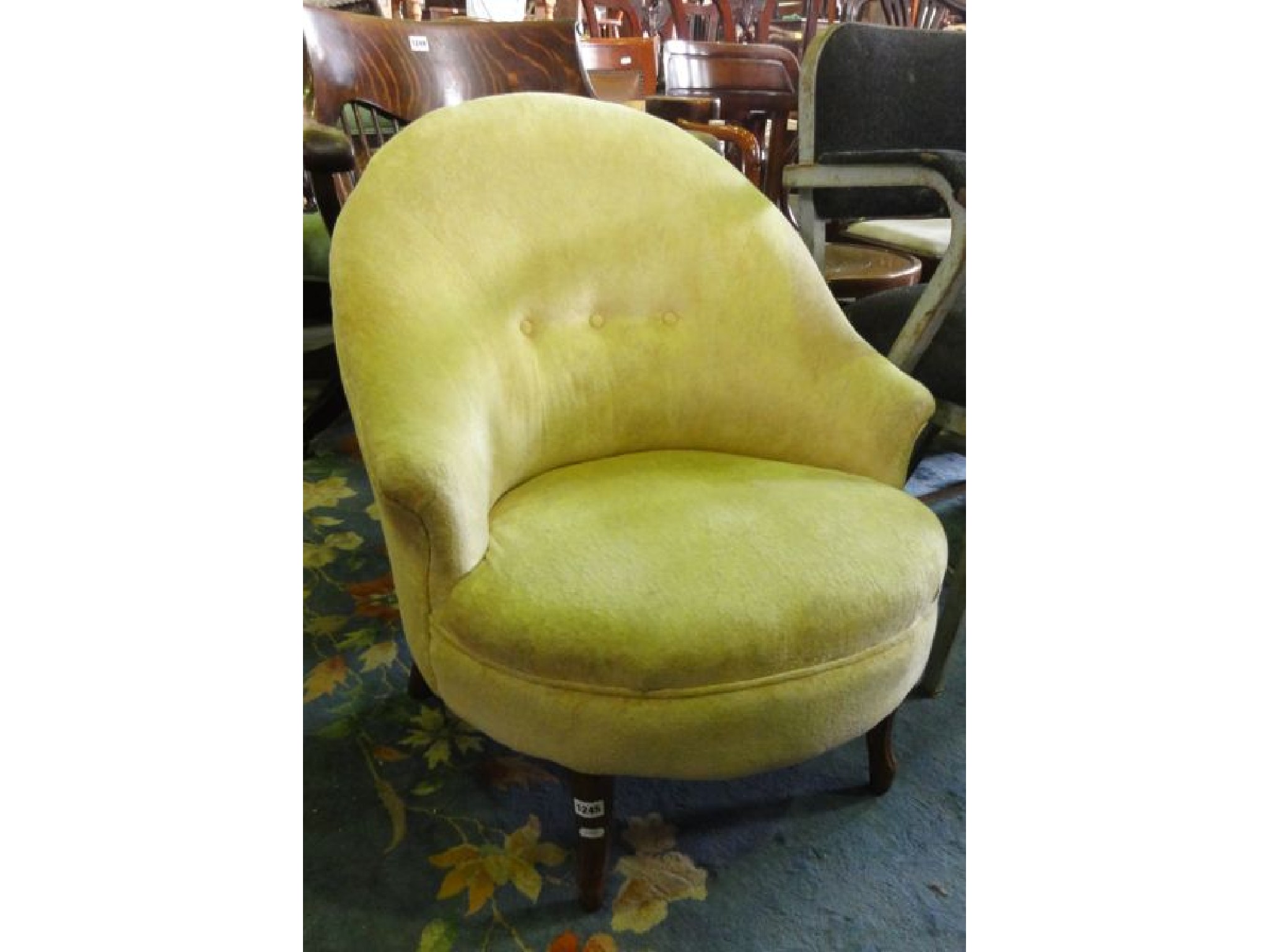 Appraisal: A low upholstered occasional chair with shaped apron and cabriole