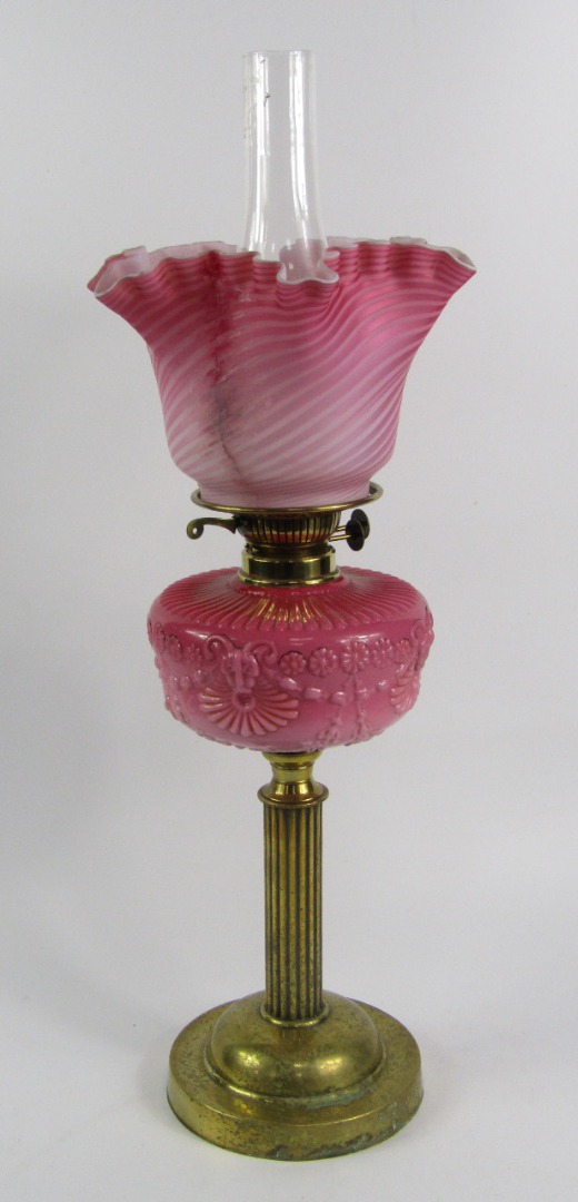 Appraisal: A Victorian brass oil lamp with a pink opaline glass