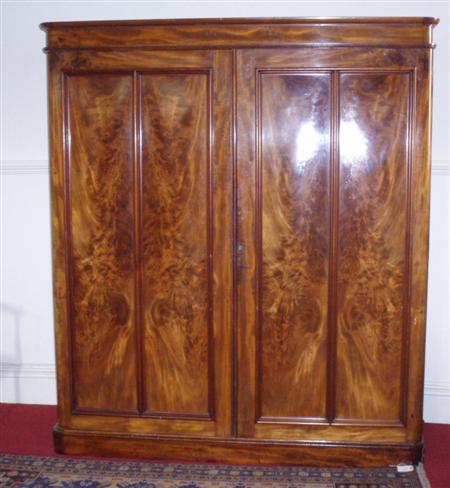 Appraisal: A large Victorian feathered mahogany two door wardrobe the projected