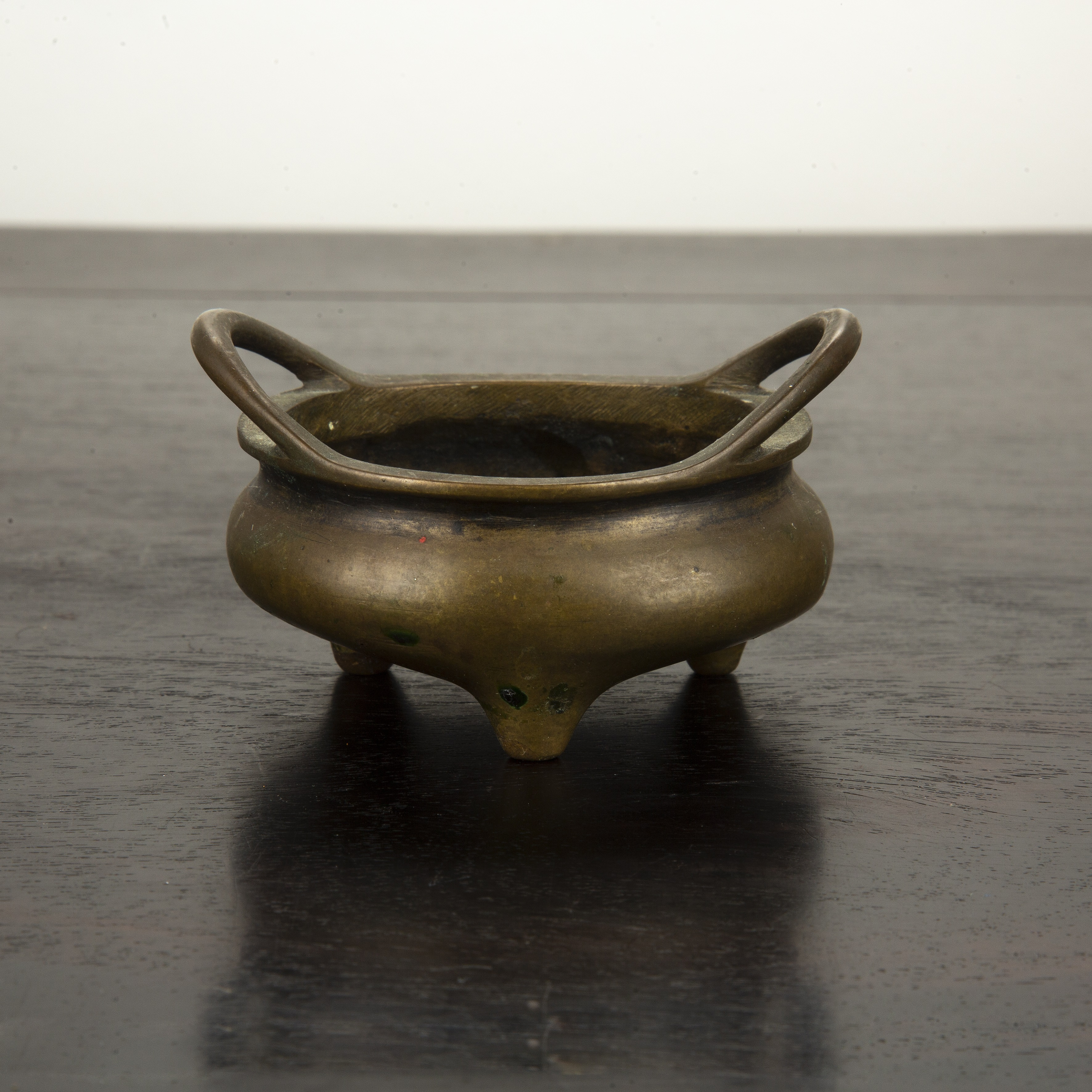 Appraisal: Miniature bronze dingChinese mid th Century with looped handles interior