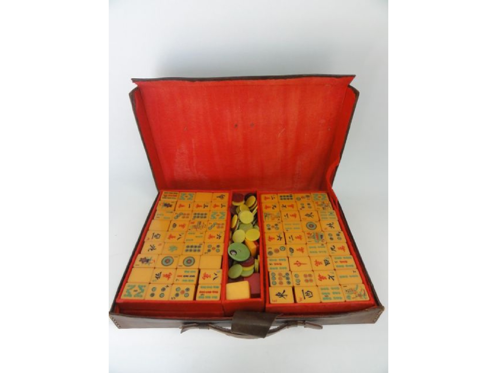 Appraisal: A vintage composition Mahjong set contained within a stitched leather