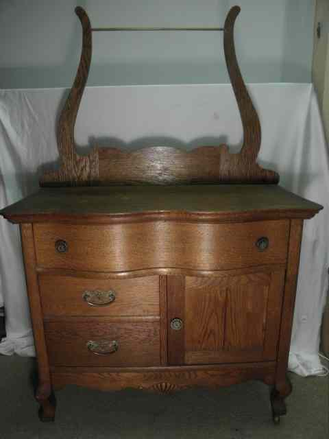 Appraisal: An American Oak washstand with attached drying rack and back