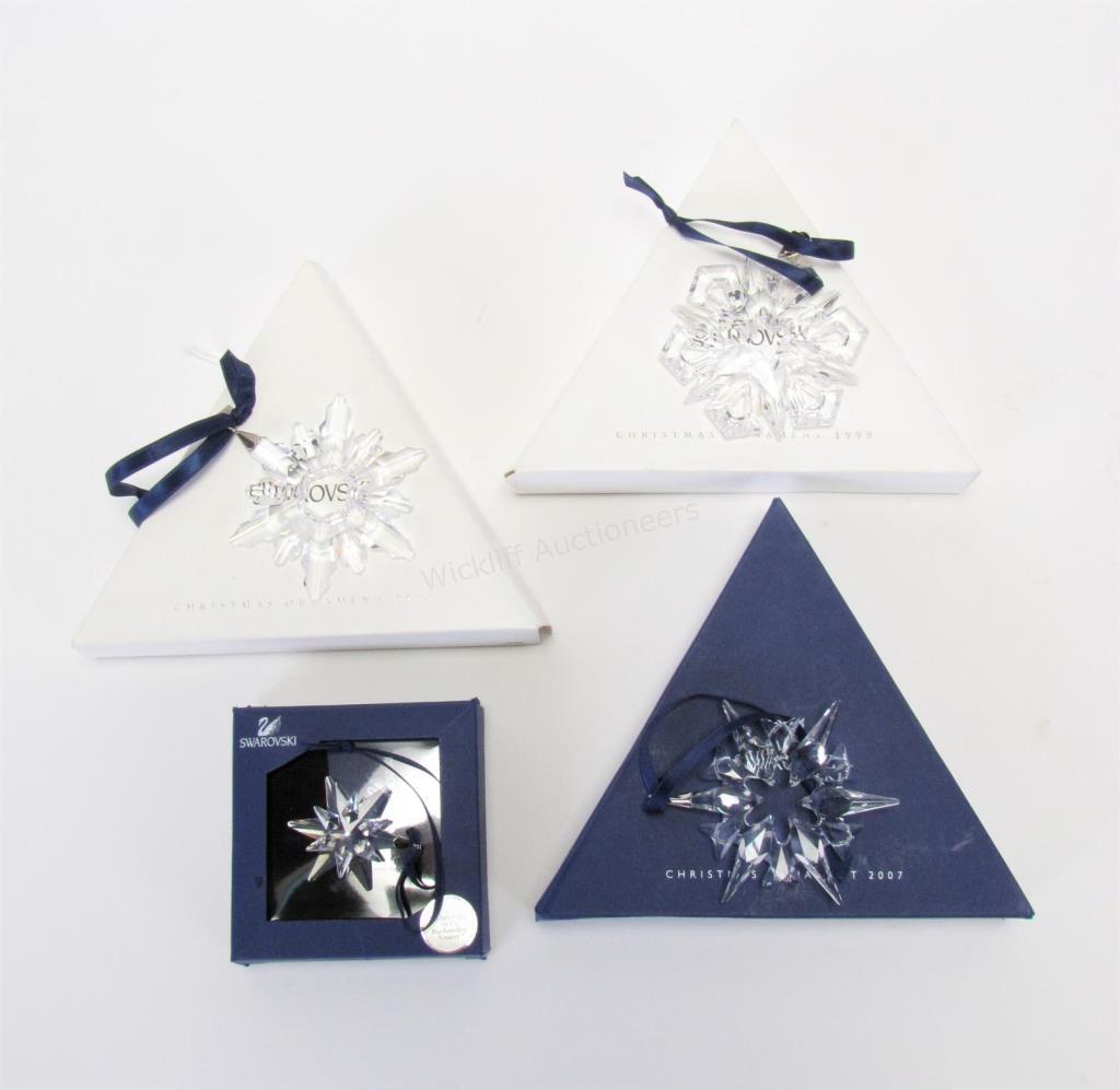 Appraisal: Four Swarovski crystal ornaments including three annual star form ornaments