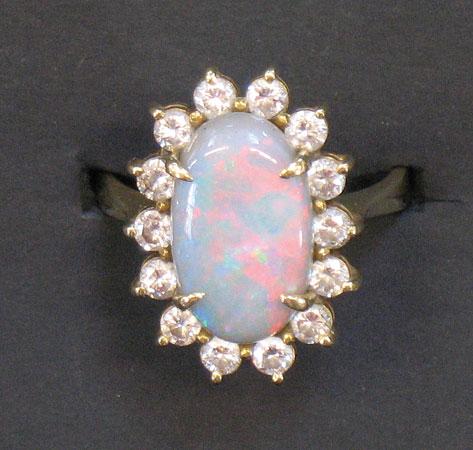 Appraisal: AN OPAL AND DIAMOND DRESS RING the central oval cabochon