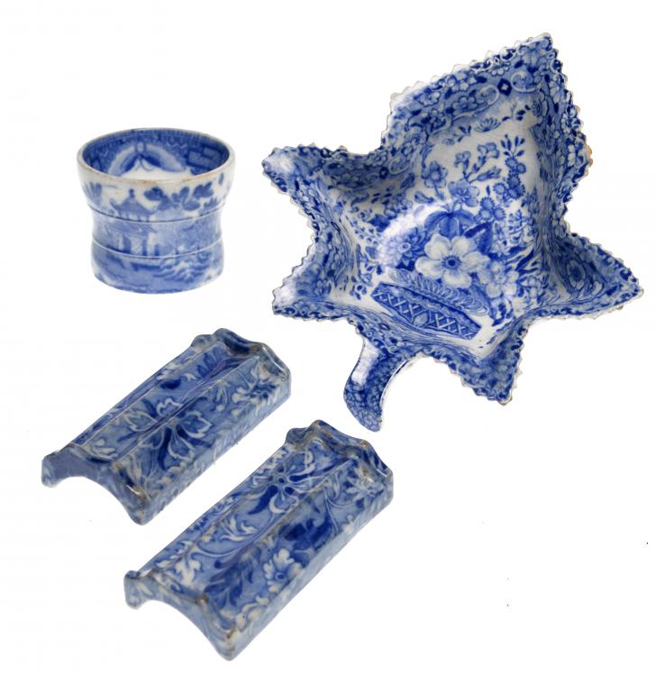 Appraisal: A PAIR OF BLUE PRINTED EARTHENWARE KNIFE-RESTS with a floral