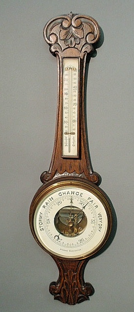 Appraisal: Aneroid barometer c with a carved oak case h x