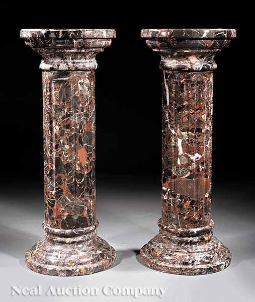 Appraisal: A Pair of Black Variegated Marble Pedestals circular tops fluted